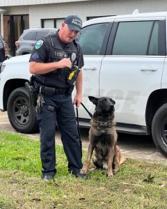 Alexandria police officer with K-9 partner during patrol, demonstrating Alexandria police officer life and community engagement in action.